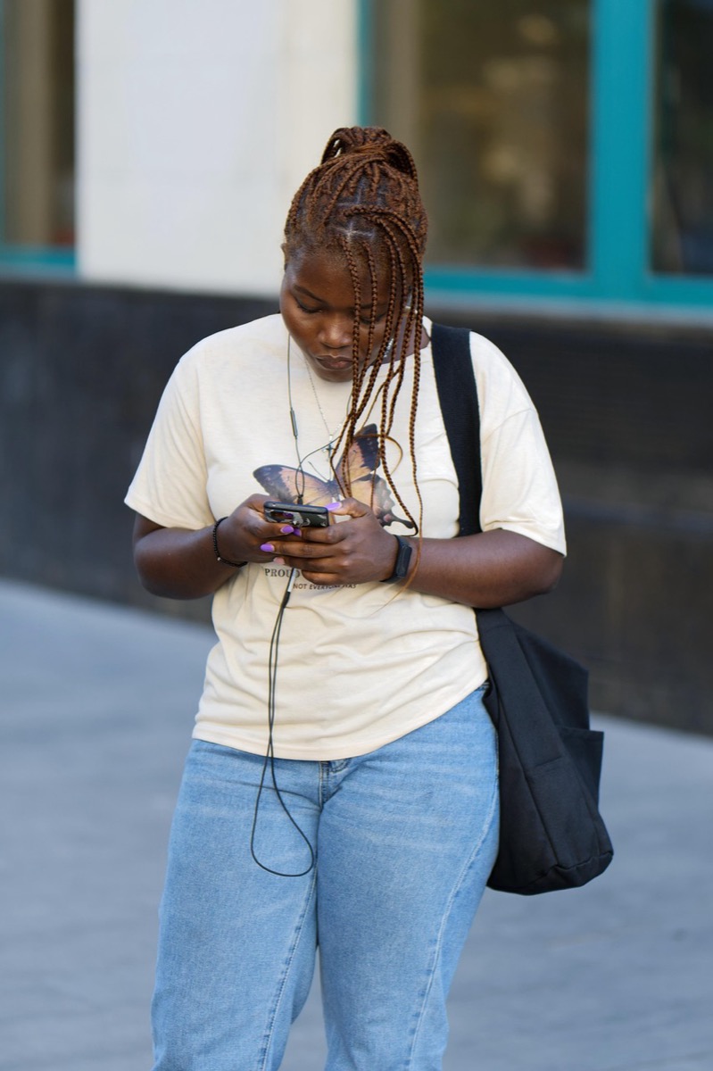 A young seller replying to customers on her phone