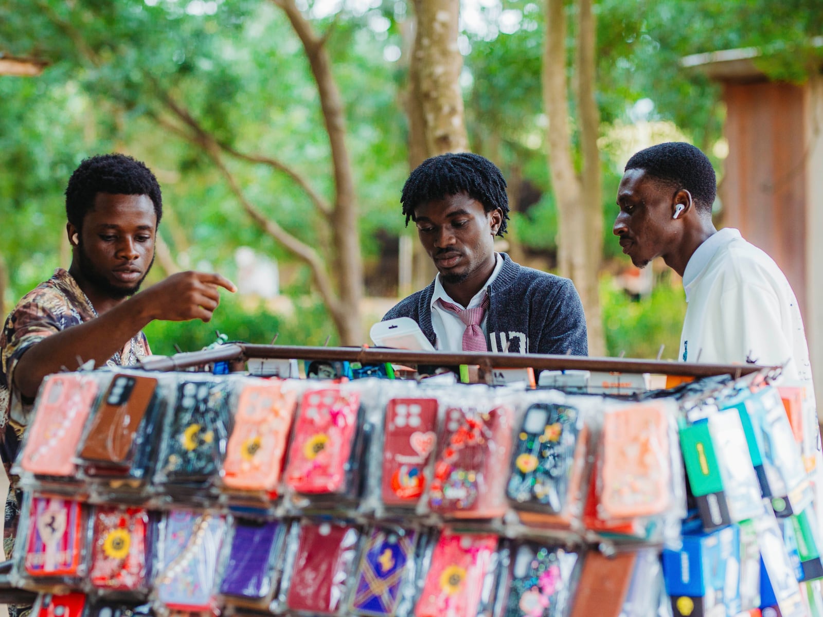 Young men browsing a phone accessories stall