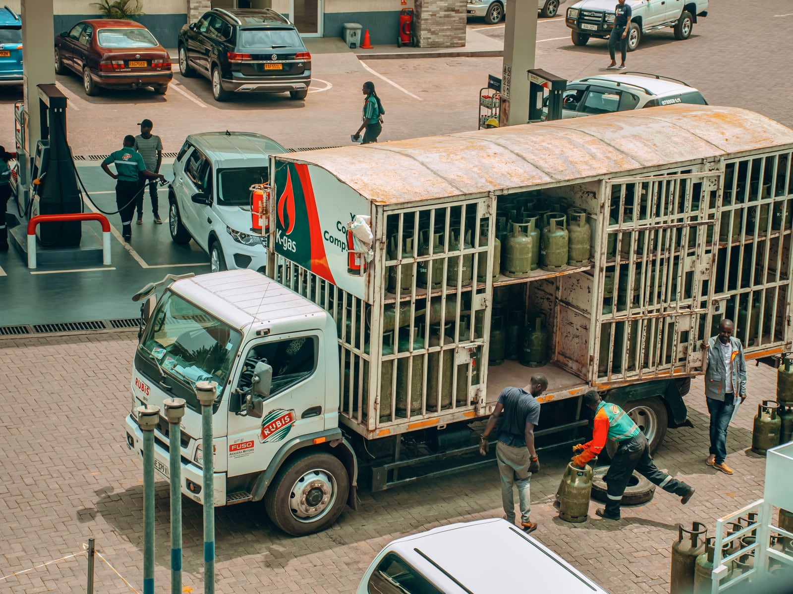 A truck loaded with cooking gas cylinders at a refill station